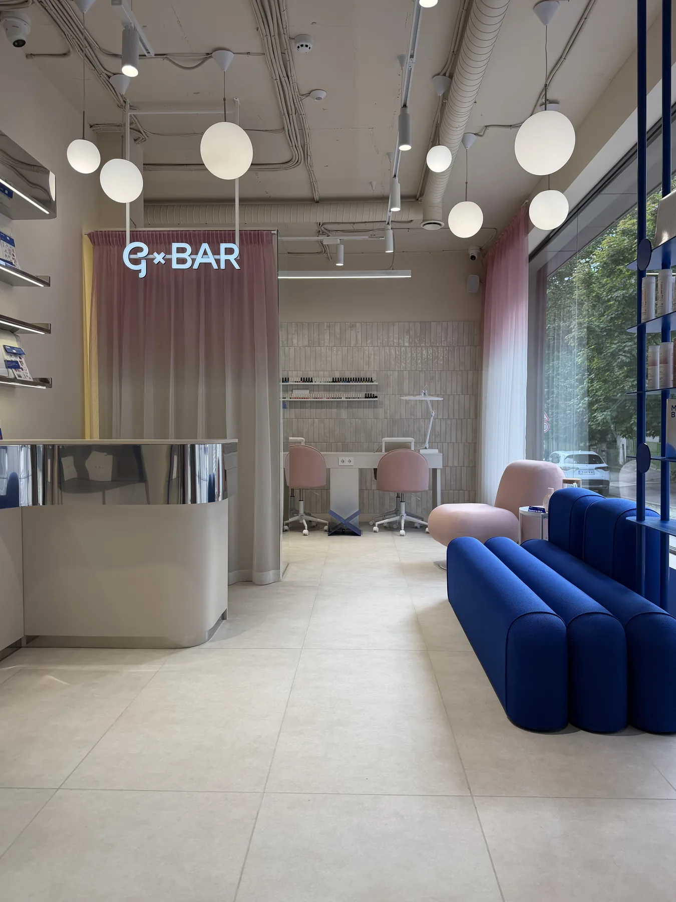 Completed renovation works for G-Bar Sofia beauty salon with branded main hall, logo wall and blue lounge seating