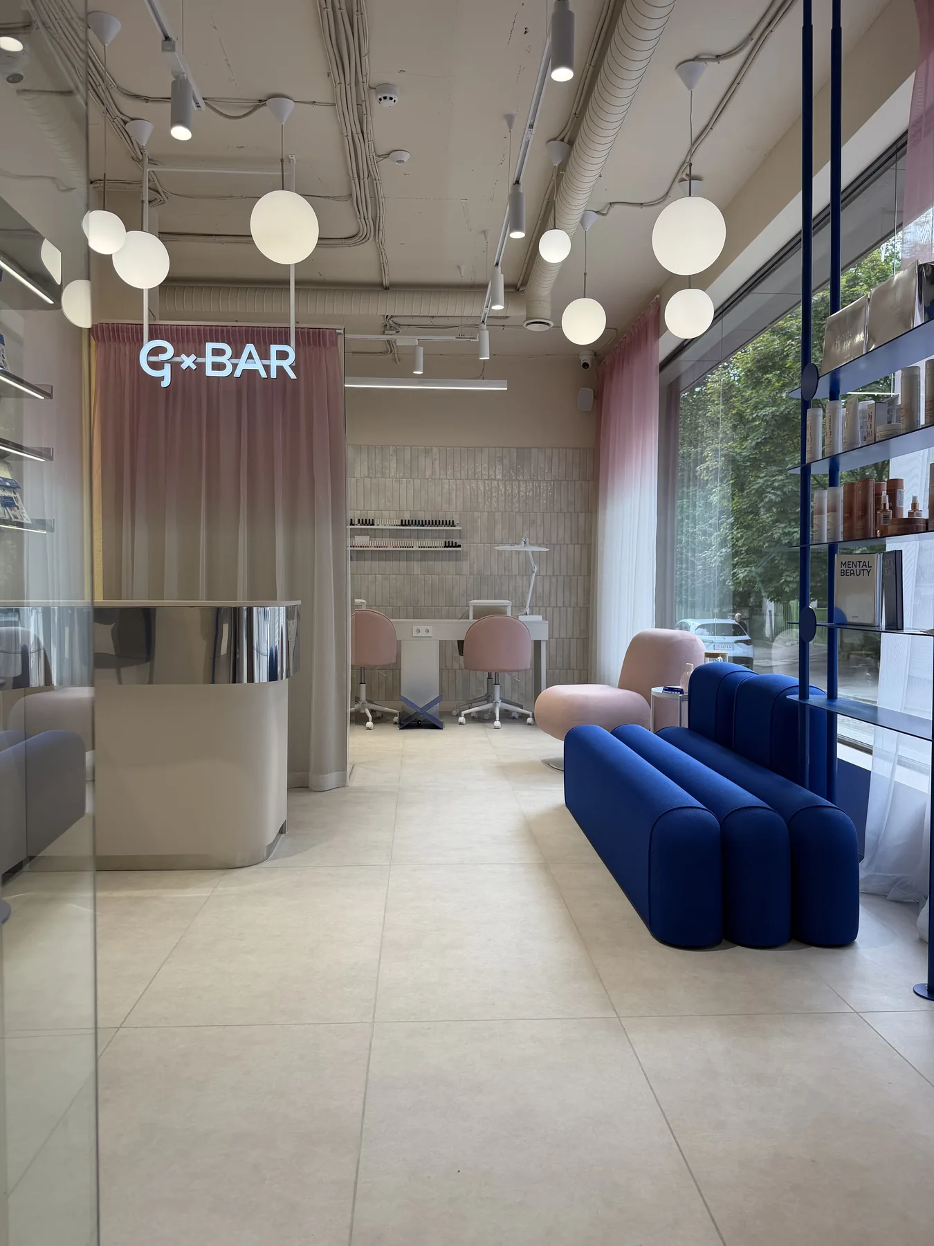 Completed G-Bar Sofia interior showing reception route, blue lounge and salon work areas