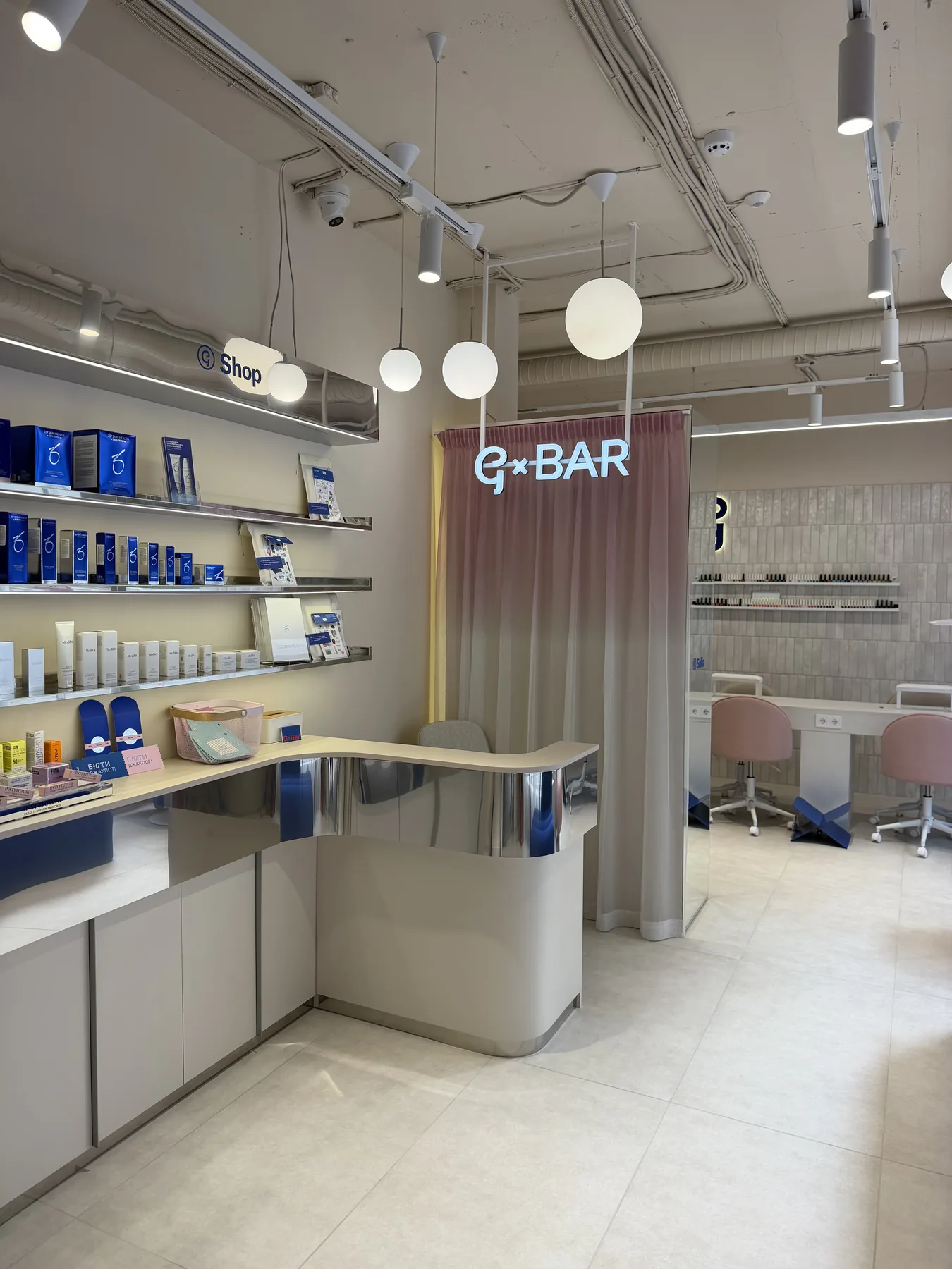Reception and retail area with illuminated shelving and logo column in G-Bar Sofia