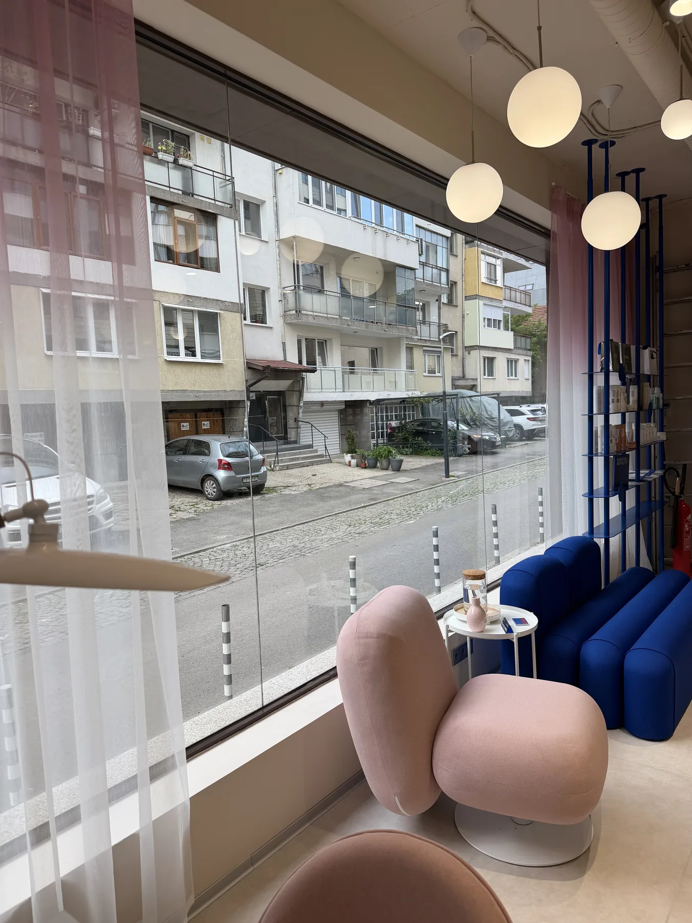 Client lounge by the window with blue seating and finished interior details