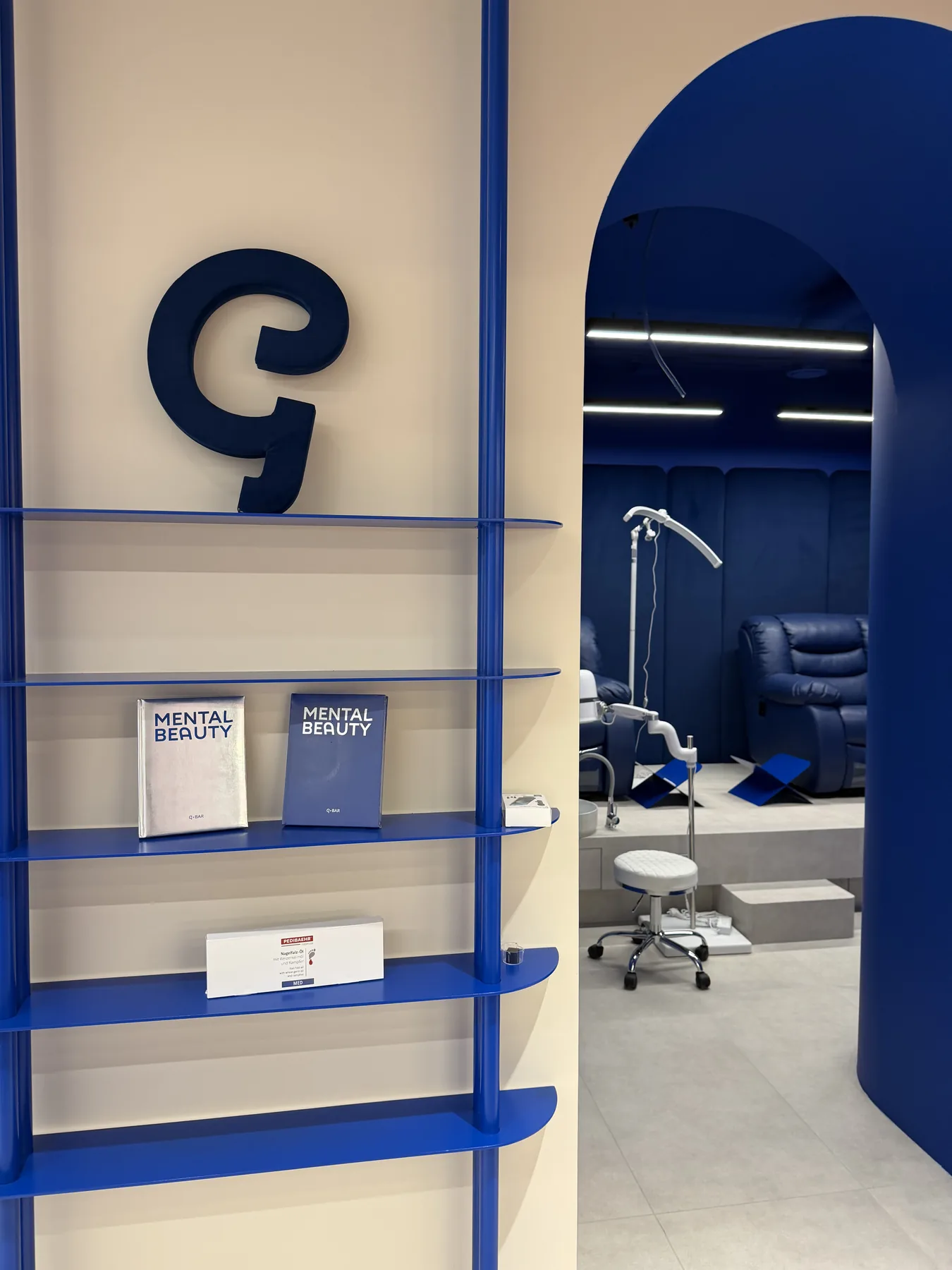Branded shelving and G-Bar logo detail in the salon interior