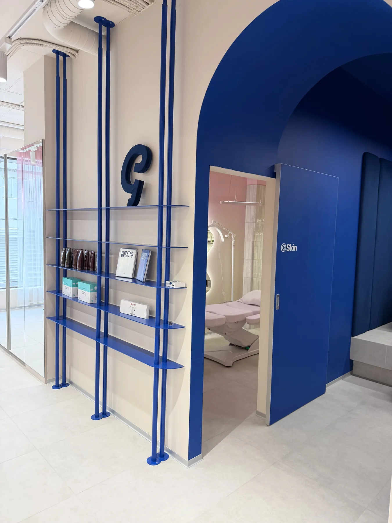 Blue arch corridor and shelving detail in G-Bar Sofia salon