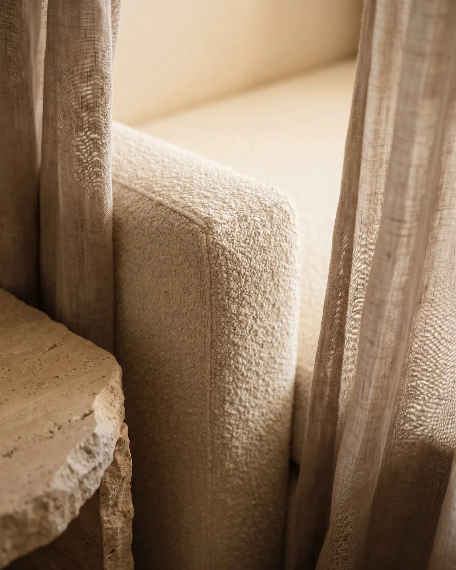 Interior design Croatia - close-up of sofa fabric, stone table and linen curtain textures
