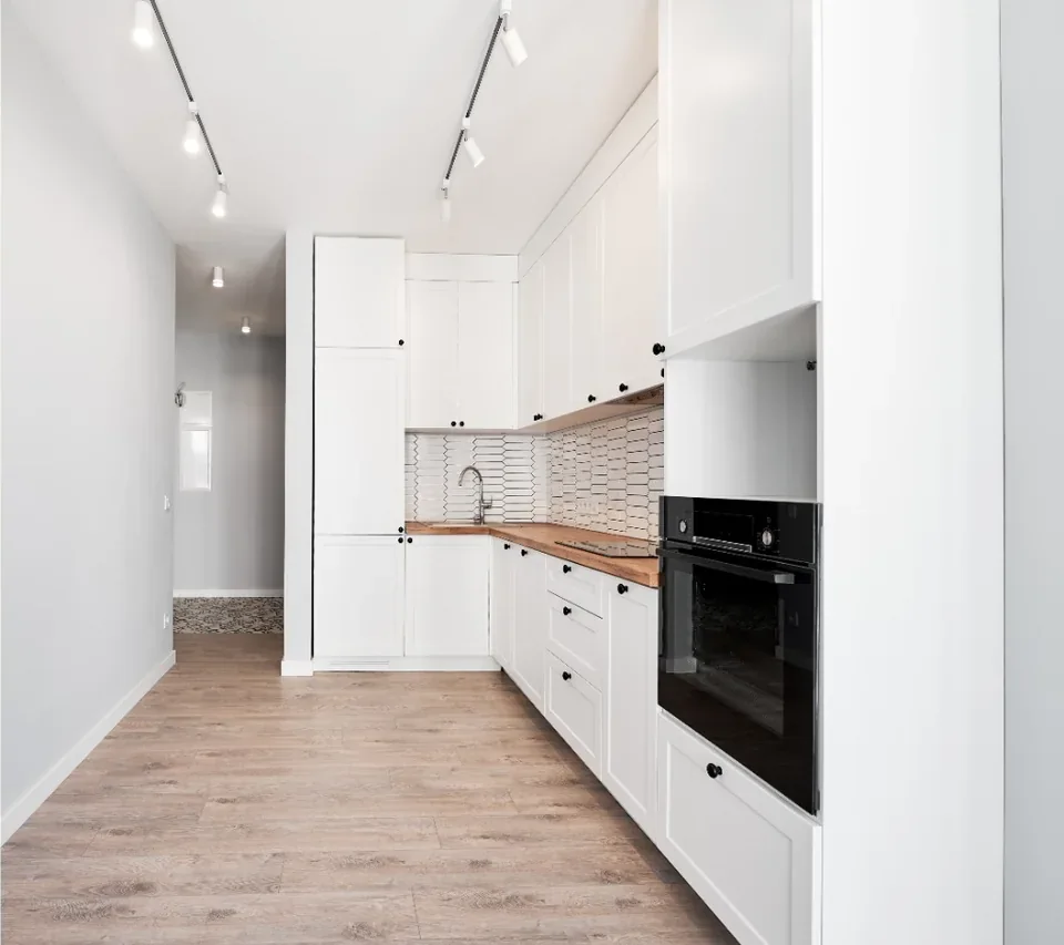 After panel showing the finished white kitchen after renovation