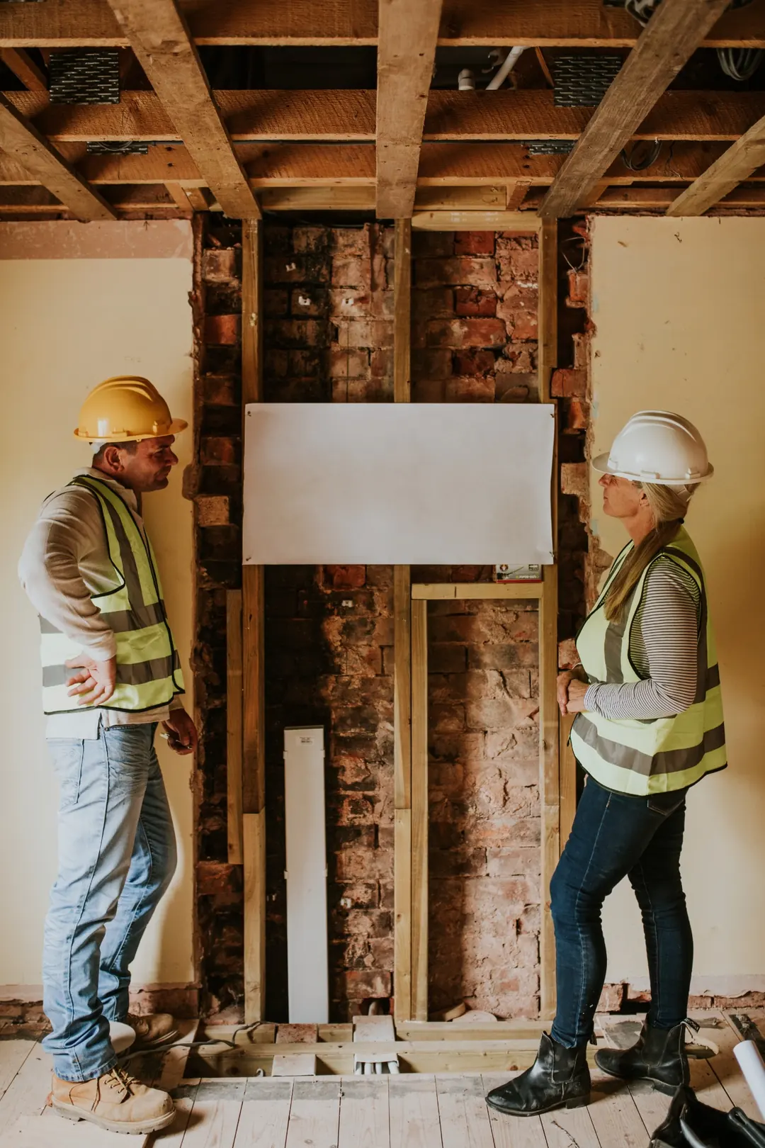 Construction team discussing renovation plans during site supervision