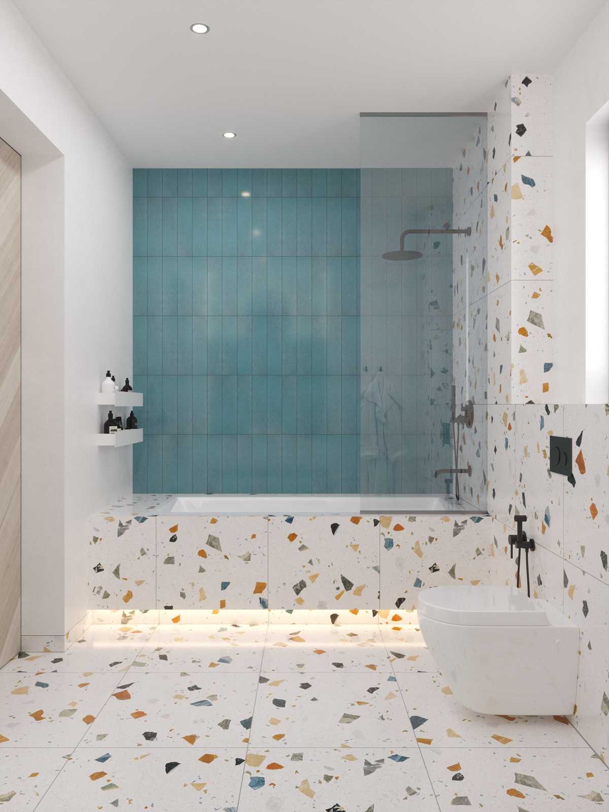 Bathroom with terrazzo tiles, blue shower wall and built-in bathtub with LED underlighting