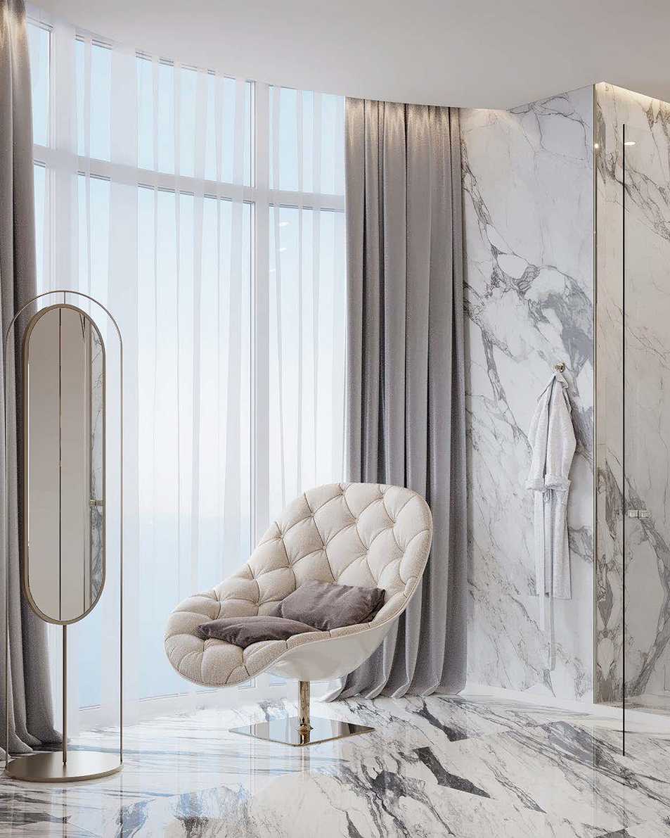 Reading corner with curved upholstered chair, floor mirror and marble floor by full-height window