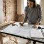 Architect reviewing apartment blueprints on site
